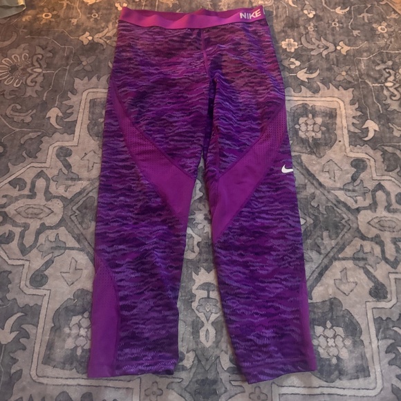 These stylish Nike capri leggings for women’s feature a vibrant purple design. - Picture 1 of 6
